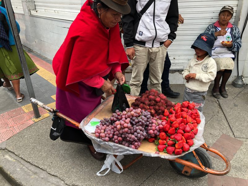 Otavaleña selling giant strawberries and grapes
